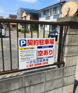 駐車場看板に防犯カメラ作動中